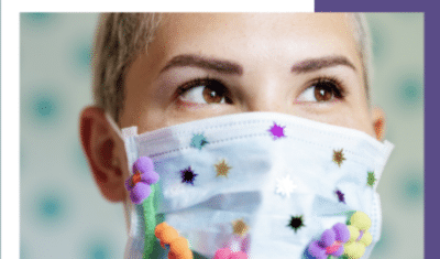 Cover of Women Enabled International 2020 Annual Report featuring a close-up image of a person wearing a brightly decorated surgical face mask gazing up and into the distance.
