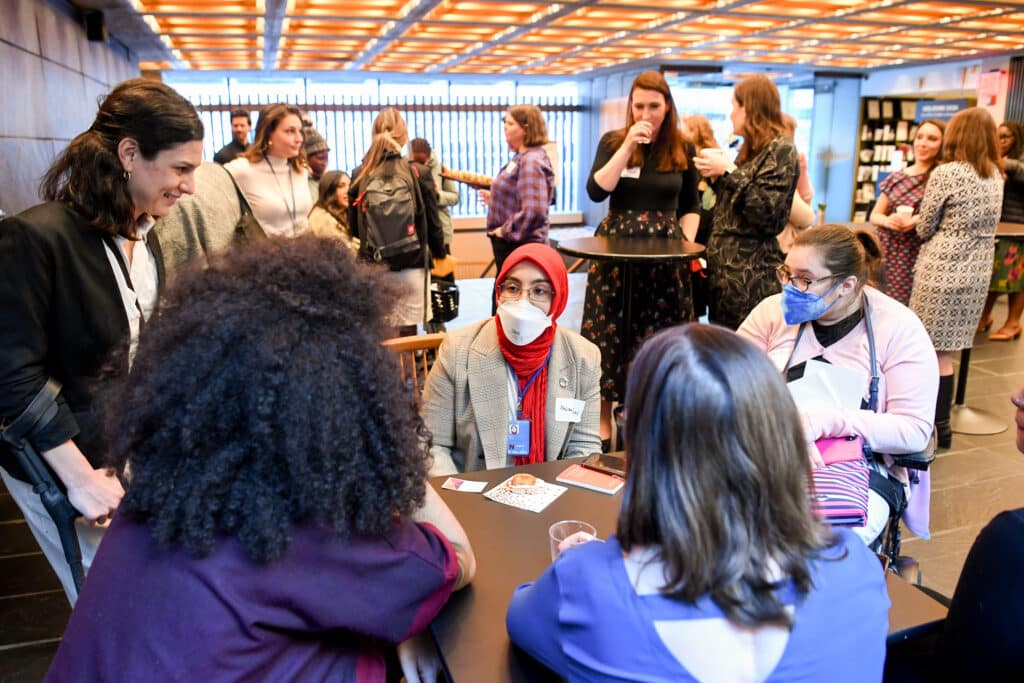 A group of women with and without disabilities meeting at a networking event convened by WEI and UAF